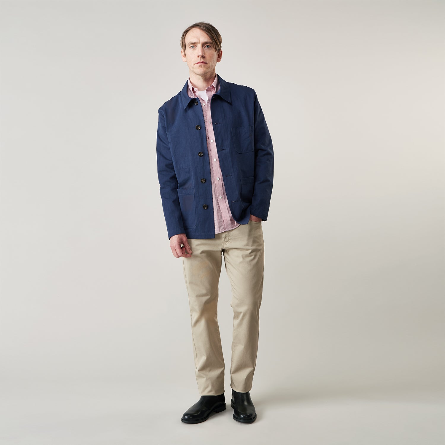 View 3 of product The Turnbull & Asser Navy Cotton-Linen Remy Chore Jacket features a collar, long sleeves, button closure, and three front pockets—a versatile minimalist essential for any men's wardrobe, shown laid flat on a white background.