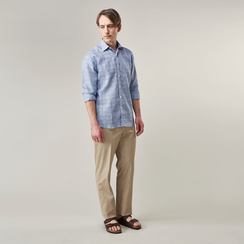 The Indigo Linen Glen Check Weekend Fit Shirt with Derby Collar by Turnbull & Asser is a light blue, long-sleeve checked linen shirt, featuring a subtle white plaid pattern and shown against a plain white background.