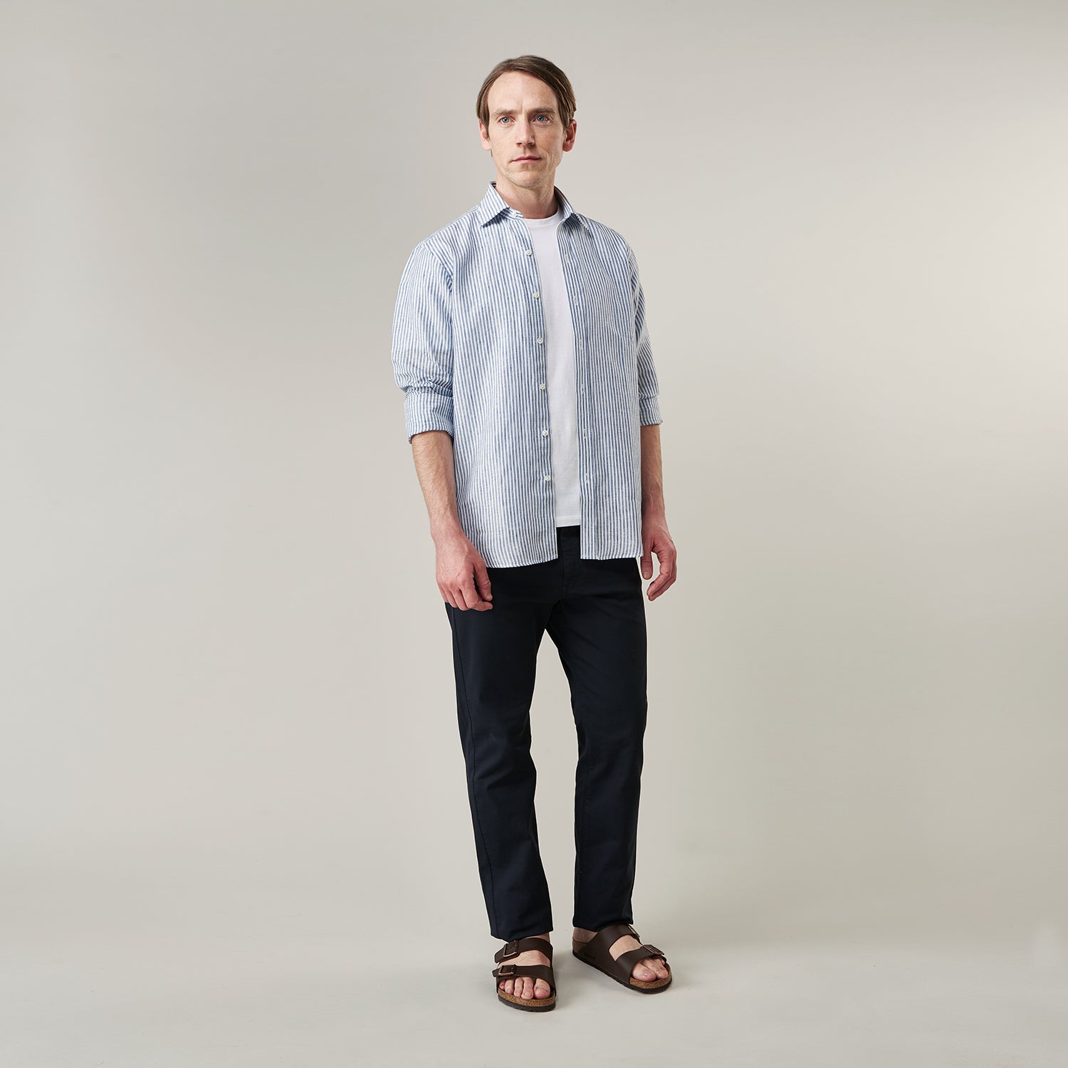 View 6 of product The Turnbull & Asser Sky Blue Linen Stripe Weekend Fit Shirt features blue and white vertical stripes, a Derby collar, and buttoned cuffs—ideal for pairing with classic cotton suits or other Weekend Fit shirts.
