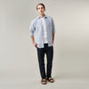 View 7 of product The Turnbull & Asser Sky Blue Linen Stripe Weekend Fit Shirt features blue and white vertical stripes, a Derby collar, and buttoned cuffs—ideal for pairing with classic cotton suits or other Weekend Fit shirts.
