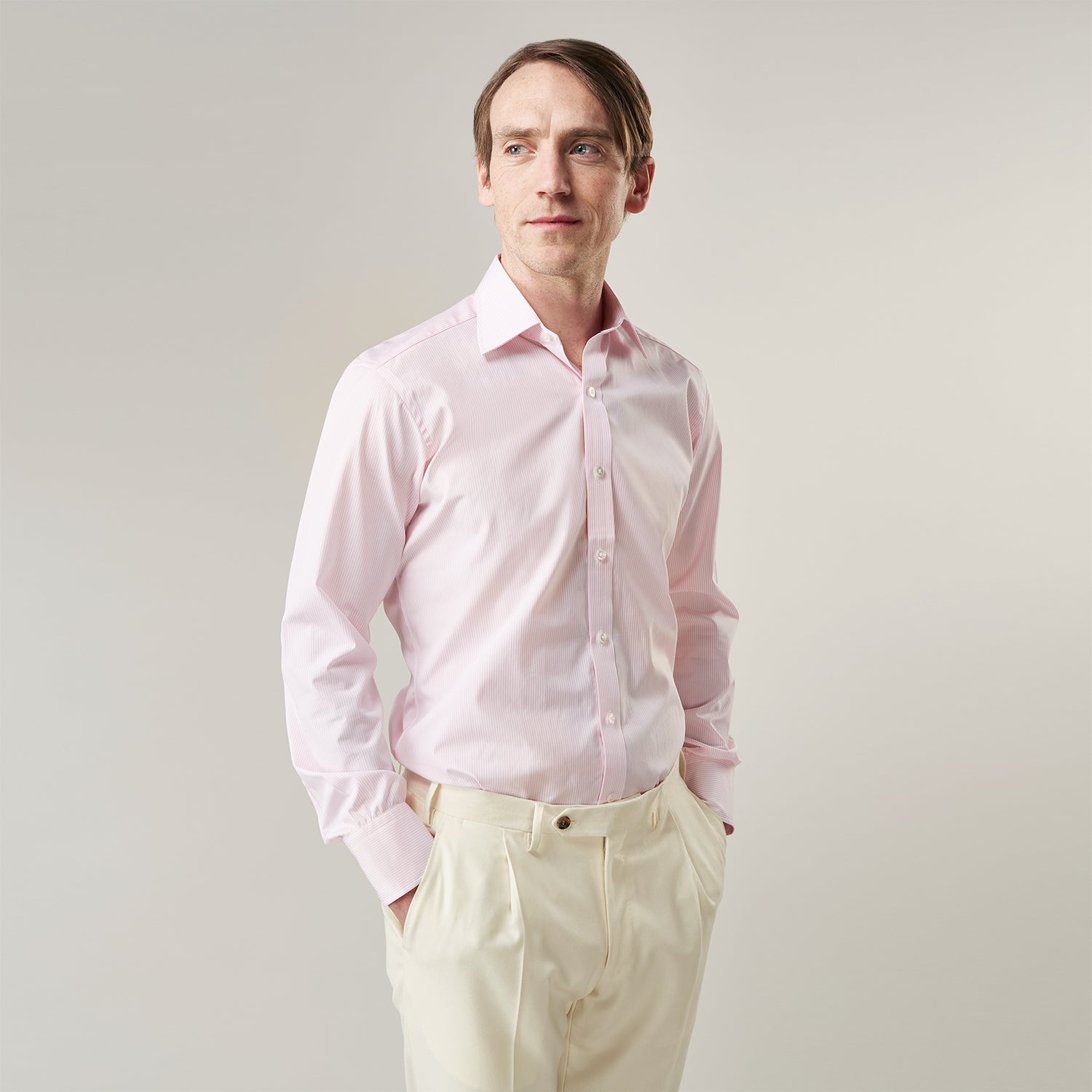 View 2 of product The Pink Fine Stripe Regular Fit Shirt with T&A Collar by Turnbull & Asser is a light pink, long-sleeve poplin shirt made from Italian cotton, featuring white buttons and shown flat on a white background.
