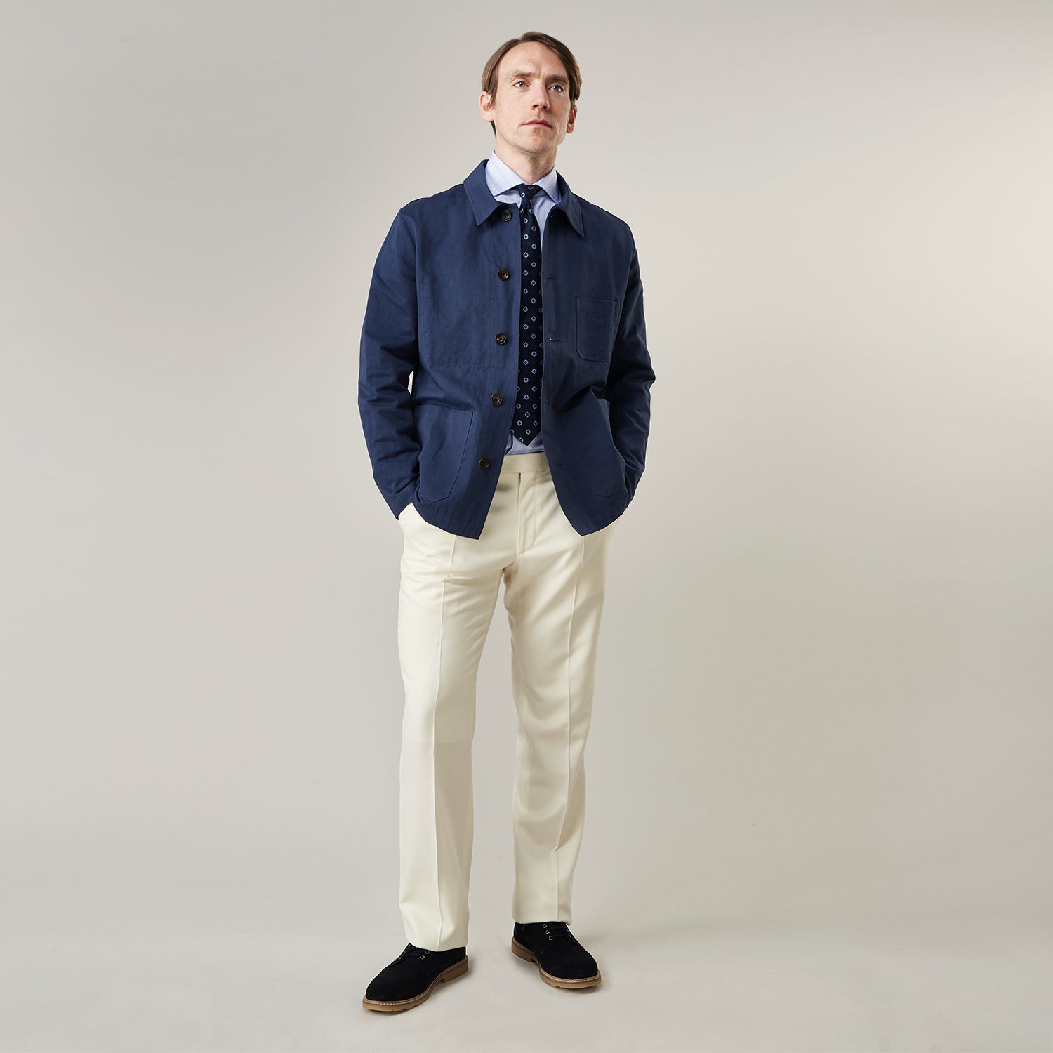 View 5 of product The Turnbull & Asser Navy Cotton-Linen Remy Chore Jacket features a collar, long sleeves, button closure, and three front pockets—a versatile minimalist essential for any men's wardrobe, shown laid flat on a white background.