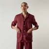 View 2 of product The Turnbull & Asser Burgundy Linen Modern Pyjama Set features a button-up, collared long-sleeve top with black piping and three pockets, plus matching pants with an elastic waistband.