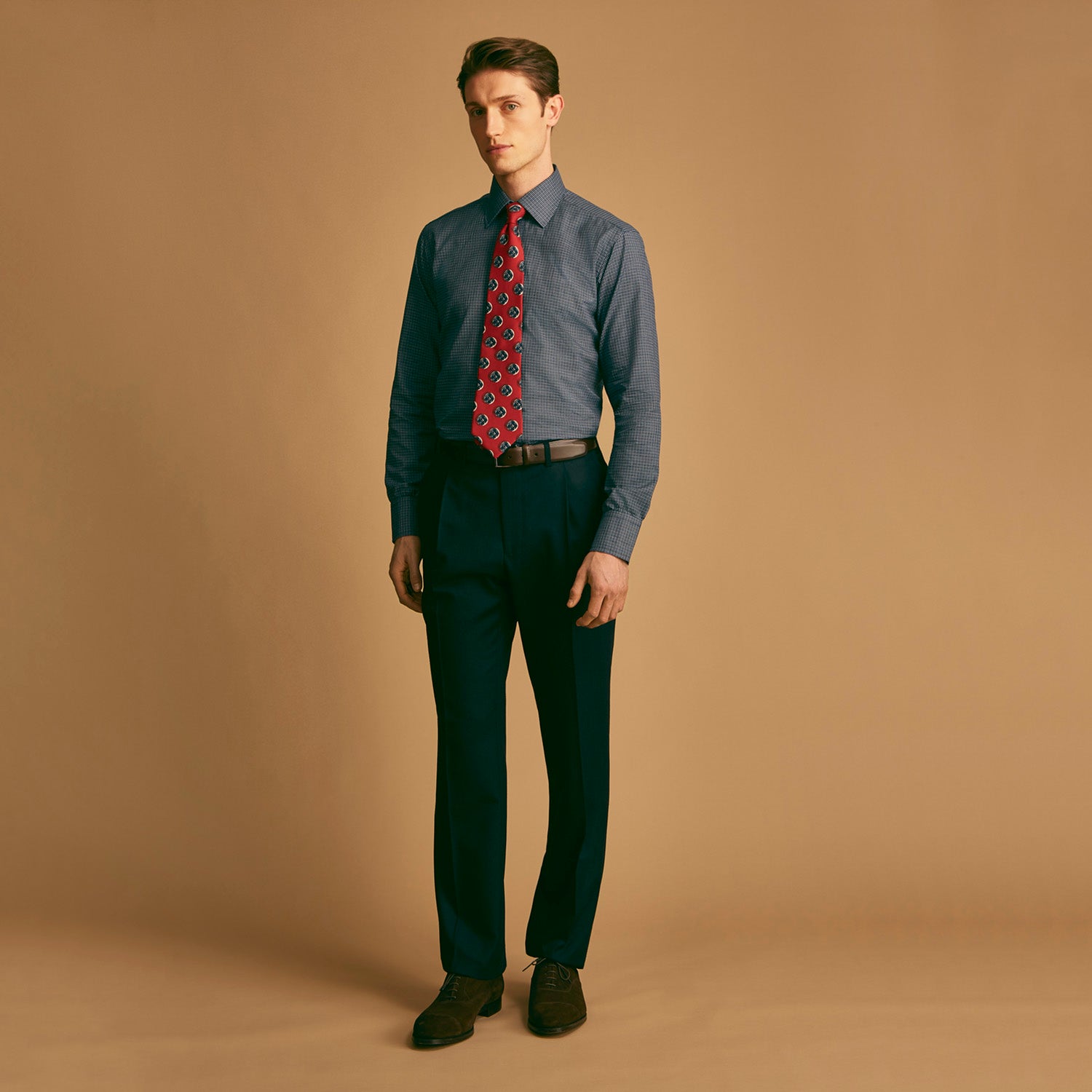 View 8 of product A man in a tie wears the Turnbull & Asser Navy Check Regular Fit Flannel Shirt with T&A collar and 3 button cuffs.