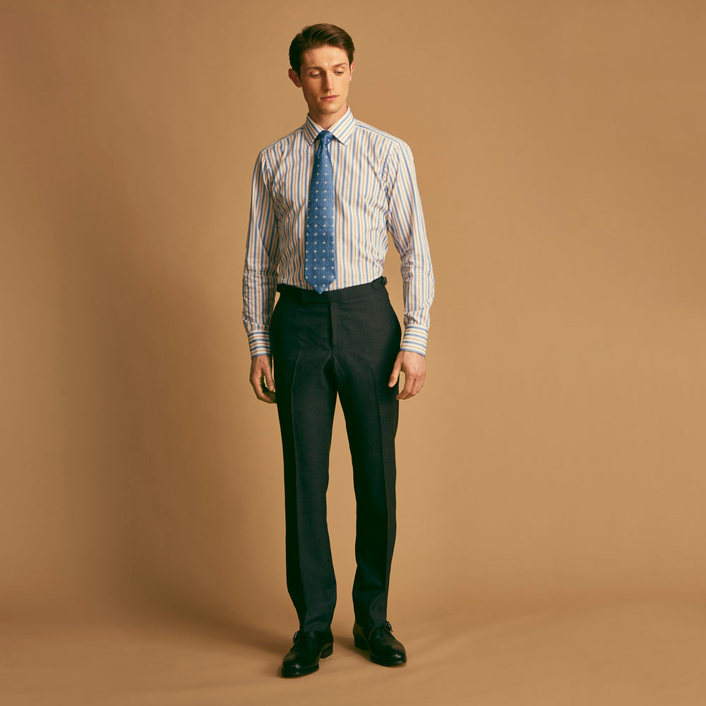 The Turnbull & Asser Blue Multi Stripe Regular Fit Shirt features a classic T&A collar, 3 button cuffs, and vertical blue, white, and yellow stripes for a timeless look.