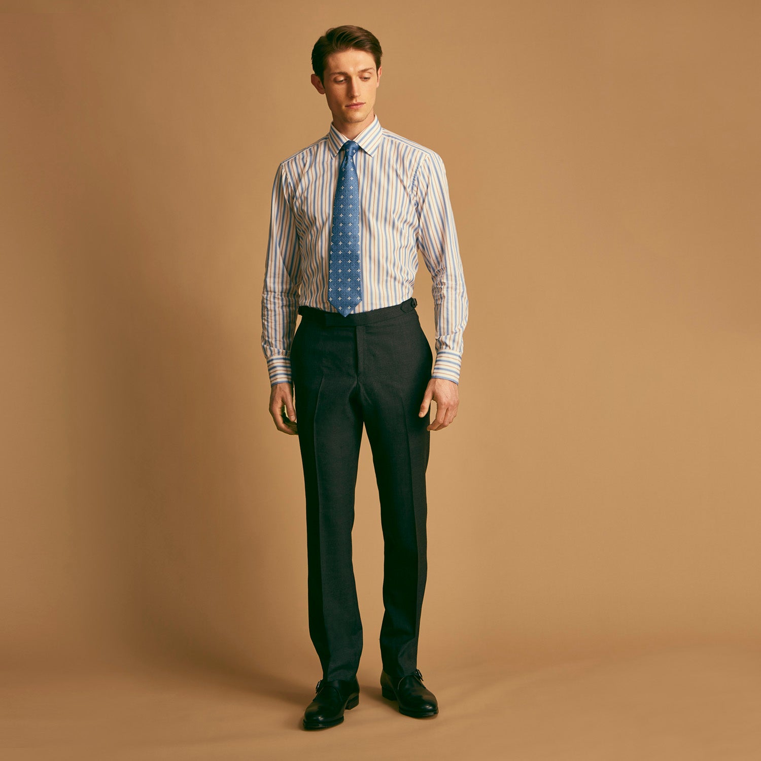 View 2 of product The Turnbull & Asser Blue Multi Stripe Regular Fit Shirt features a classic T&A collar, 3 button cuffs, and vertical blue, white, and yellow stripes for a timeless look.