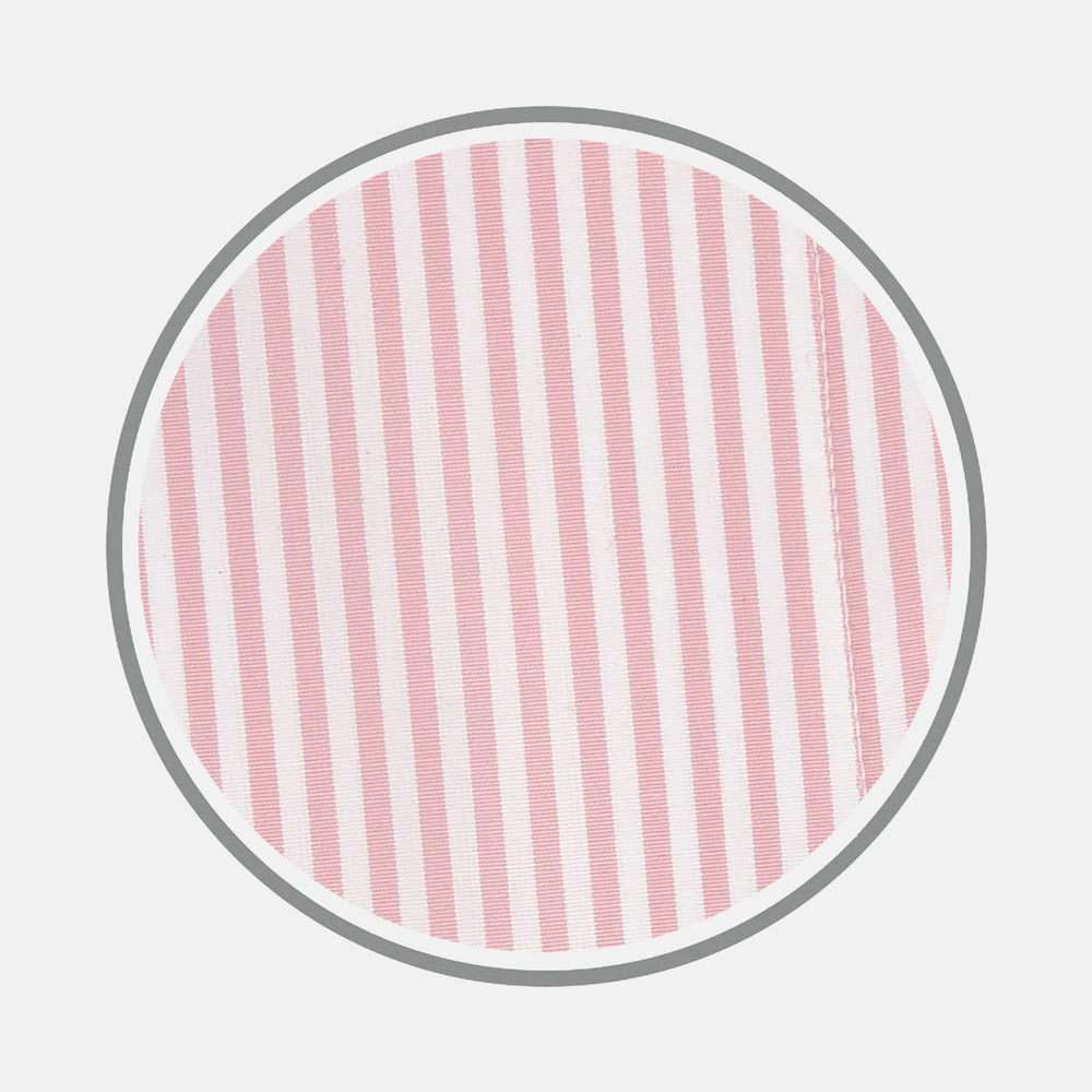 Close-up of Turnbull & Asser's Pink Bengal Stripe Cotton Fabric, featuring pink and white vertical stripes within a circular frame on a white background. A seam appears near the right edge of the fabric.