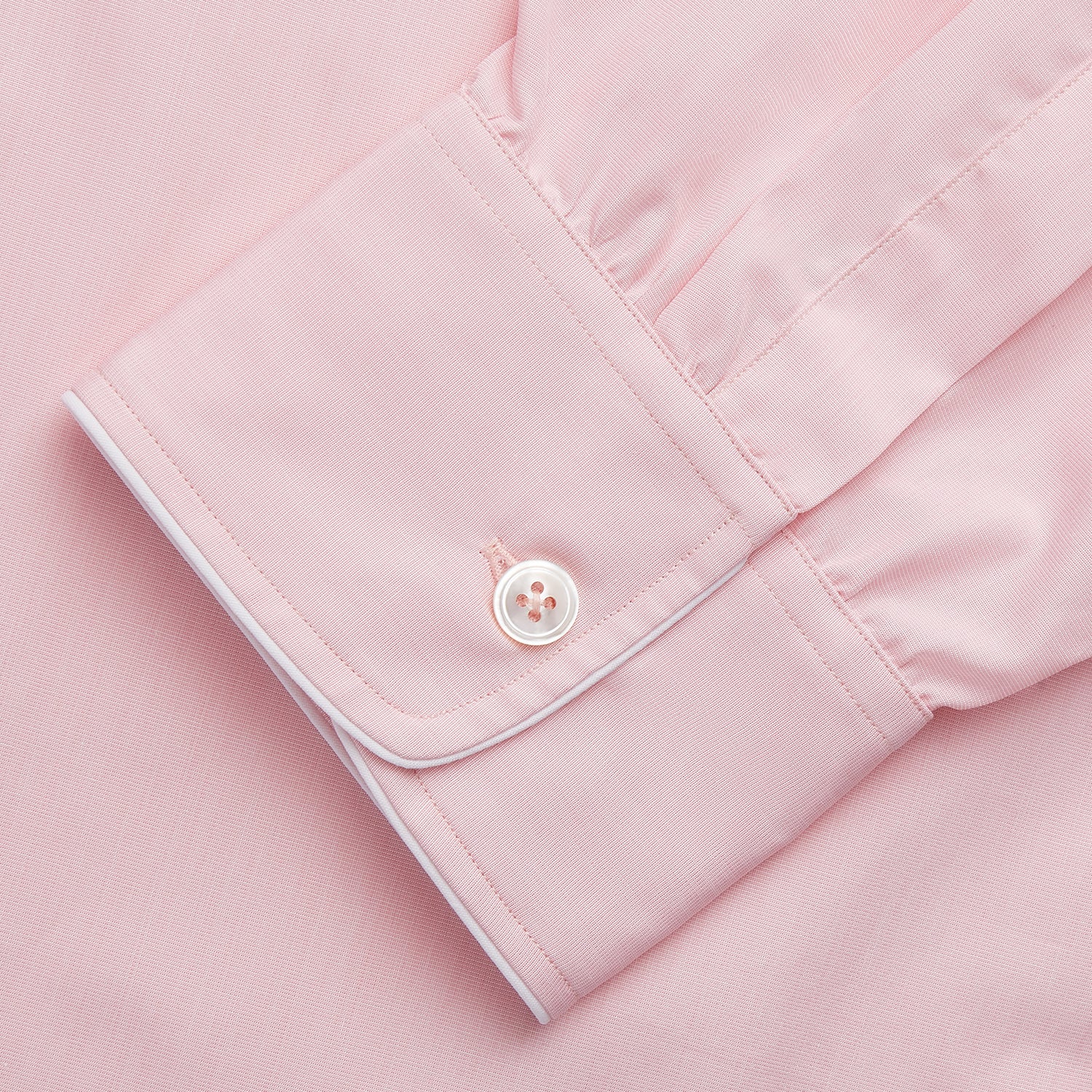 View 4 of product The Turnbull & Asser Pink Piped End-On-End Cotton Nightshirt features long sleeves, a pointed collar, button-down front, chest pocket, and a curved high-low hem for timeless, relaxed style.