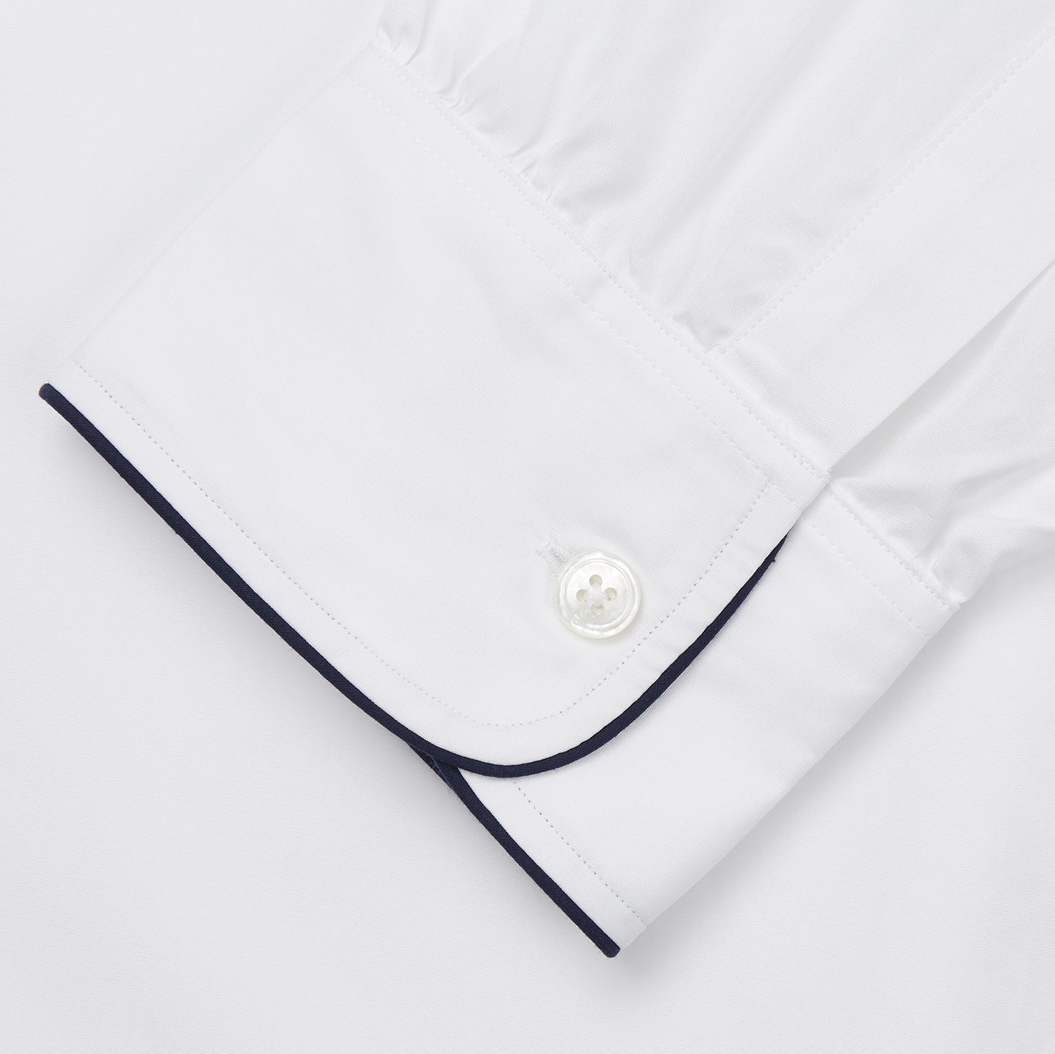 View 3 of product The Turnbull & Asser White Piped Cotton Nightshirt features black piping on the collar, chest pocket, and cuffs, plus a curved hem and loose-fitting sleeves gathered at the wrists for a classic look.
