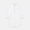 View 1 of product The Turnbull & Asser White Piped Cotton Nightshirt features black piping on the collar, chest pocket, and cuffs, plus a curved hem and loose-fitting sleeves gathered at the wrists for a classic look.