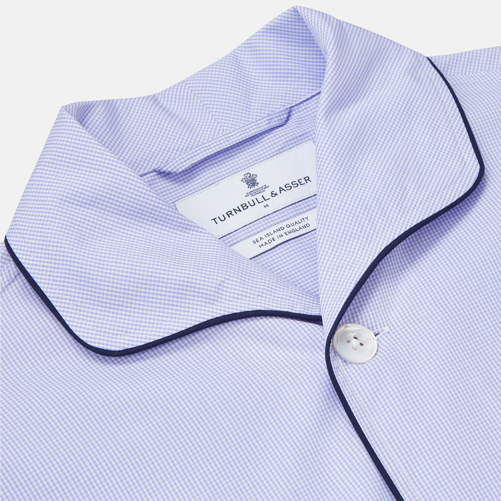 Turnbull & Asser's Blue Fine Check Piped Sea Island Quality Cotton Pyjama Set features white buttons, black piping on the collar, cuffs, and pocket, with matching drawstring pants—displayed flat on a white background.