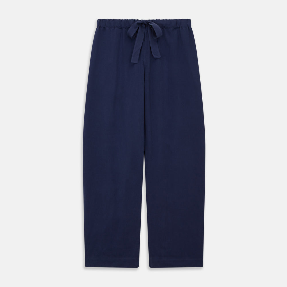 The Women's Harriet Navy Silk Pyjama Set by Turnbull & Asser features a long-sleeve, button-up top with white piping and chest pocket, plus matching drawstring pants—luxurious sleepwear displayed on a white background.