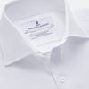 View 3 of product The Turnbull & Asser White Organic Cotton Tailored Fit Hove Shirt is a classic long-sleeve dress shirt with a button-down front and collar, crafted from soft organic cotton and shown on a white background.