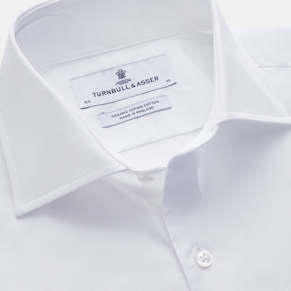 The Turnbull & Asser White Organic Cotton Tailored Fit Hove Shirt is a classic long-sleeve dress shirt with a button-down front and collar, crafted from soft organic cotton and shown on a white background.