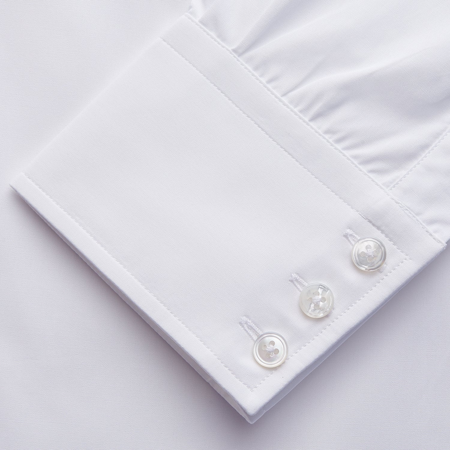 View 2 of product The Turnbull & Asser White Organic Cotton Tailored Fit Hove Shirt is a classic long-sleeve dress shirt with a button-down front and collar, crafted from soft organic cotton and shown on a white background.