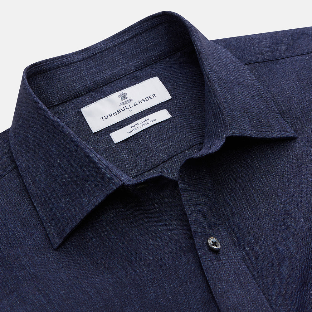 The Turnbull & Asser Navy Weekend Fit Linen Finch Shirt features a Derby collar and chest pocket, crafted from dark blue linen—ideal for casual style or adding to your weekend shirts rotation.