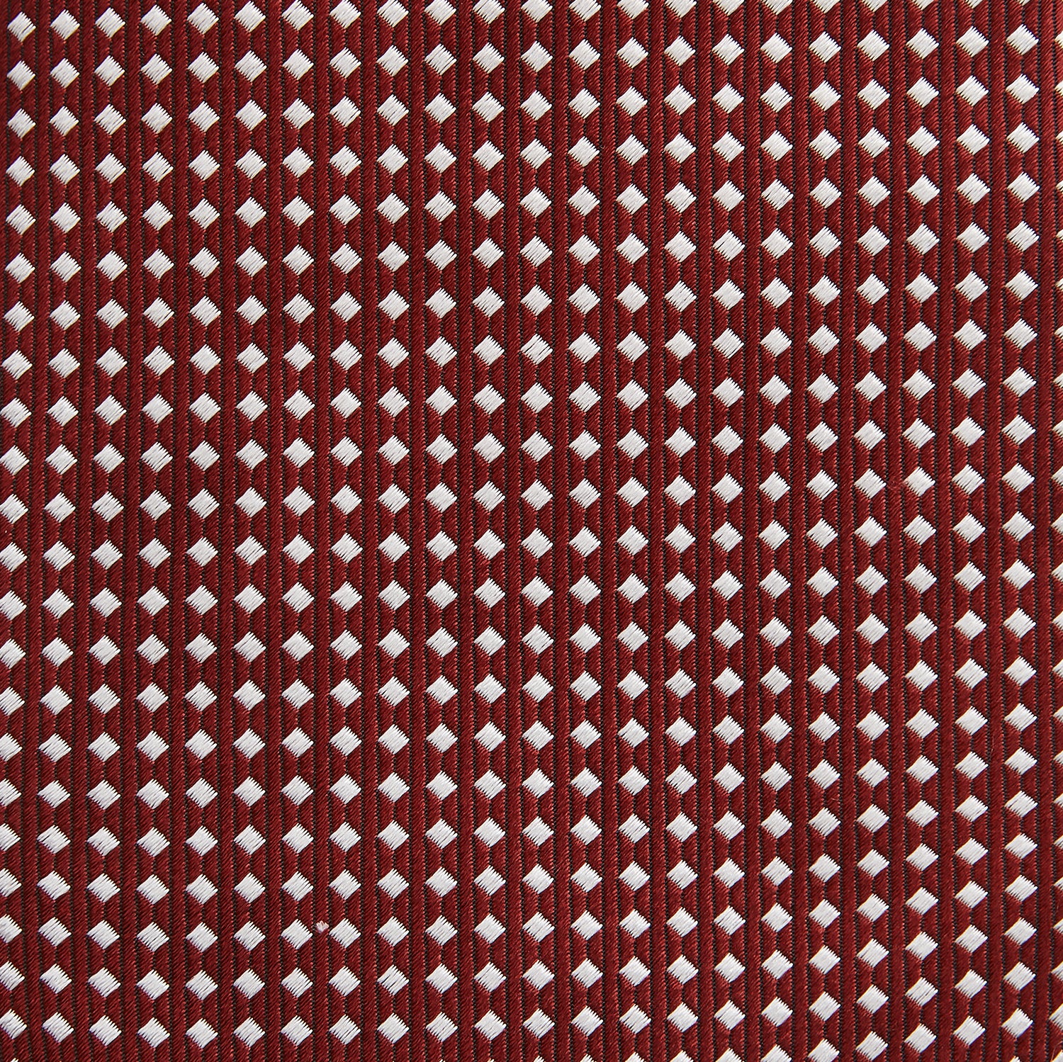 View 3 of product The Turnbull & Asser Burgundy and White Diamond Silk Tie features a rolled-up design with a repeating white diamond pattern on burgundy, shown on a plain white background—a timeless accent for any office shirt.
