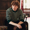 View 2 of product The Holly Green Knitted Cashmere Crewneck Jumper by Turnbull & Asser features a ribbed neckline, cuffs, and hem—a timeless investment piece for fans of signature knits.