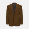 View 1 of product The Turnbull & Asser Tobacco Plainweave Cashmere Jacket is a single-breasted brown summer jacket with two buttons, notch lapels, and flap pockets, tailored in Italy and shown on a plain white background.