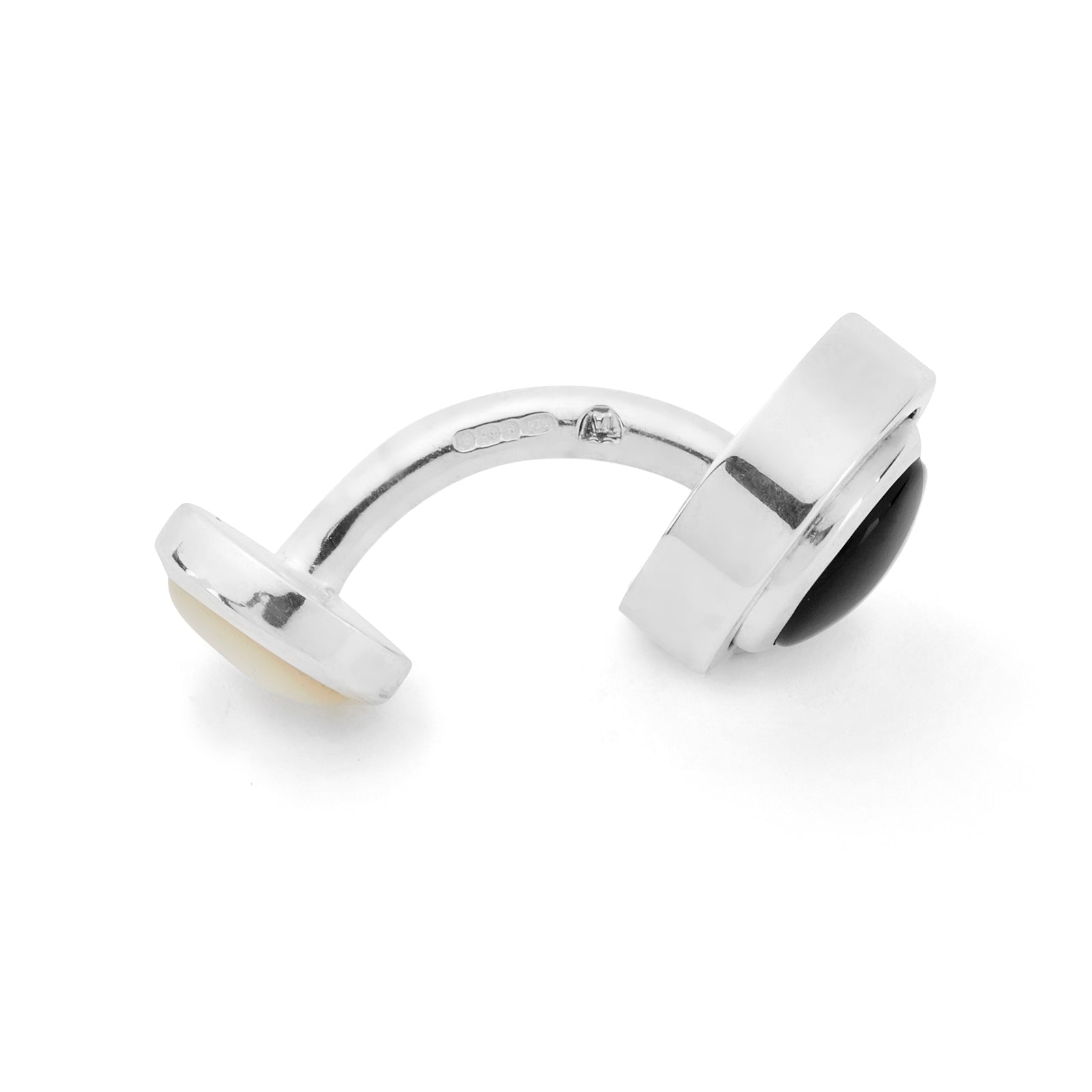 View 3 of product Turnbull & Asser’s Reversible Monochrome Sterling Silver Round Cufflinks feature elegant edges with one white mother-of-pearl center and the other a black onyx center, shown on a plain light gray background.