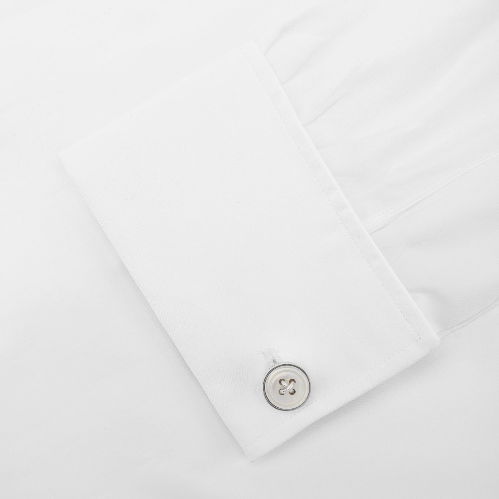 View 3 of product Turnbull & Asser's White Sterling Silver Mother-of-Pearl Button Cufflinks, designed with a four-hole button motif and mother-of-pearl center, are displayed on a light gray background.