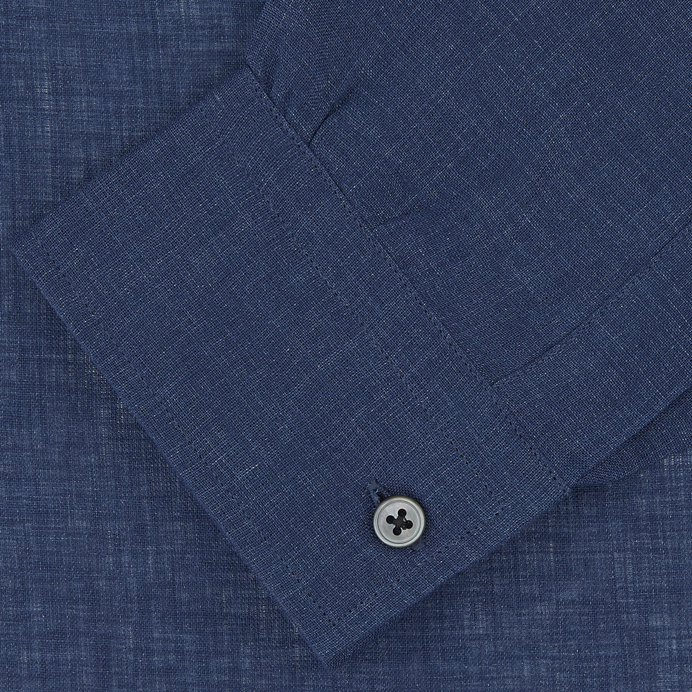 The Turnbull & Asser Weekend Fit Navy Linen Shirt features a Dorset collar, long sleeves with 1-button cuffs, and a button-up front, neatly folded and displayed against a plain white background.