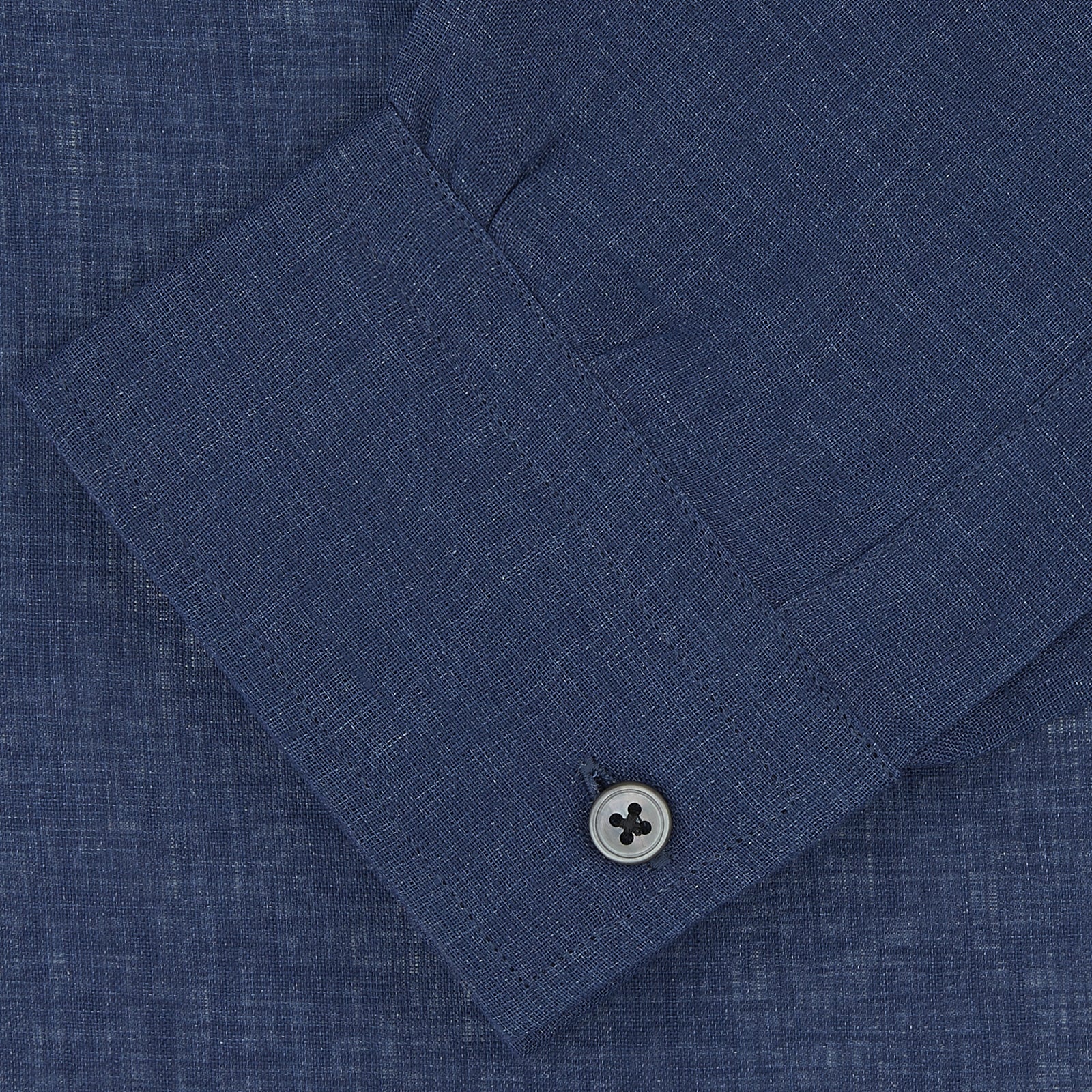View 2 of product The Turnbull & Asser Weekend Fit Navy Linen Shirt features a Dorset collar, long sleeves with 1-button cuffs, and a button-up front, neatly folded and displayed against a plain white background.