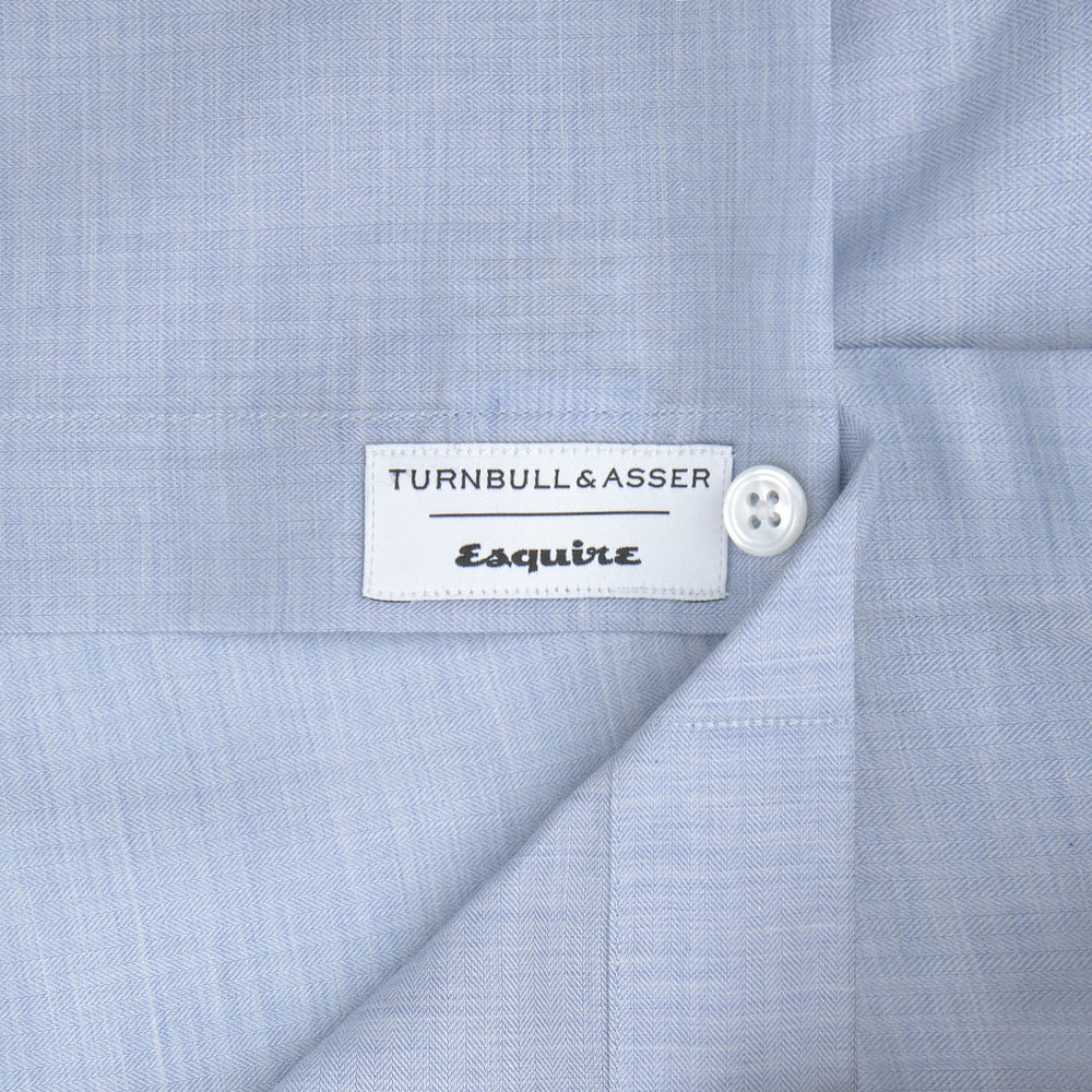 The Wine Piped Silk Pyjama Set by Turnbull & Asser, neatly folded, showcases classic piping details and a luxurious silk finish, presented against a plain white background.