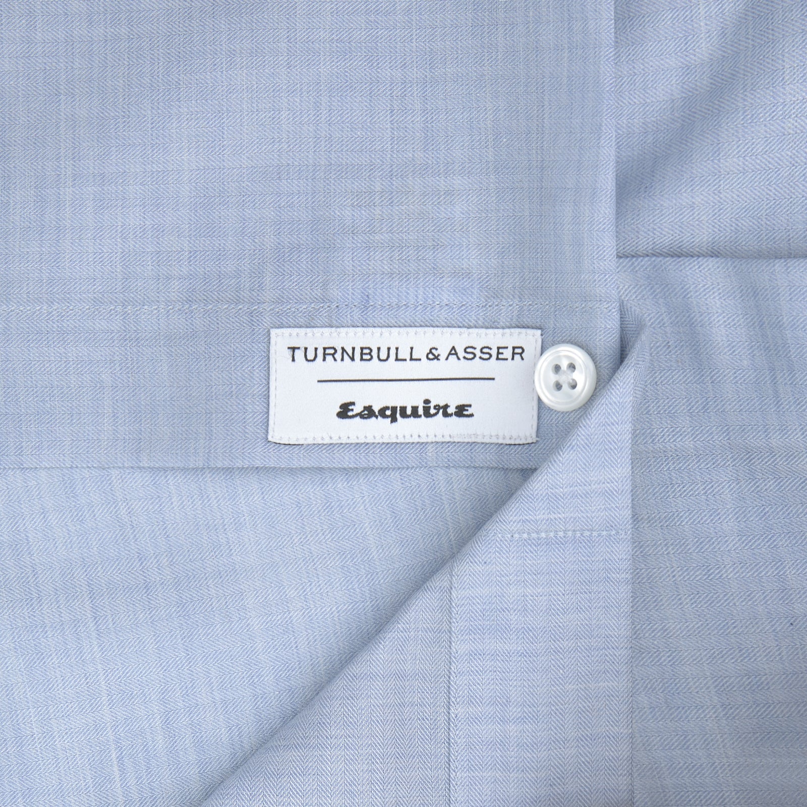 View 2 of product The Wine Piped Silk Pyjama Set by Turnbull & Asser, neatly folded, showcases classic piping details and a luxurious silk finish, presented against a plain white background.