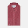View 1 of product The Turnbull & Asser Weekend Fit Red Linen Shirt features a Dorset collar, 1-button cuff, white buttons, and patch pocket. The long-sleeve shirt is neatly folded and displayed on a plain white background.