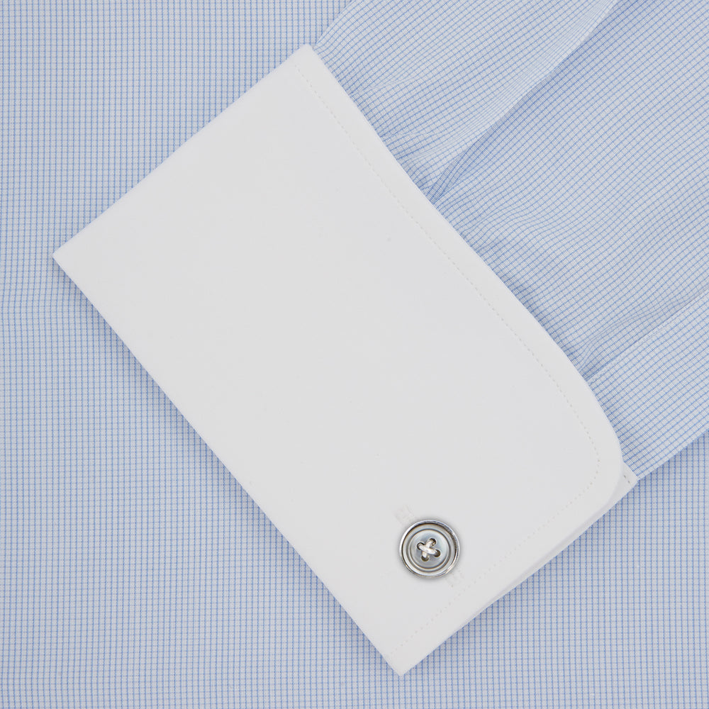 A neatly folded The Great Gatsby Cotton Shirt by Turnbull & Asser, featuring a light blue body, white rounded collar, and double cuffs inspired by 1920s style, displayed on a plain light background.