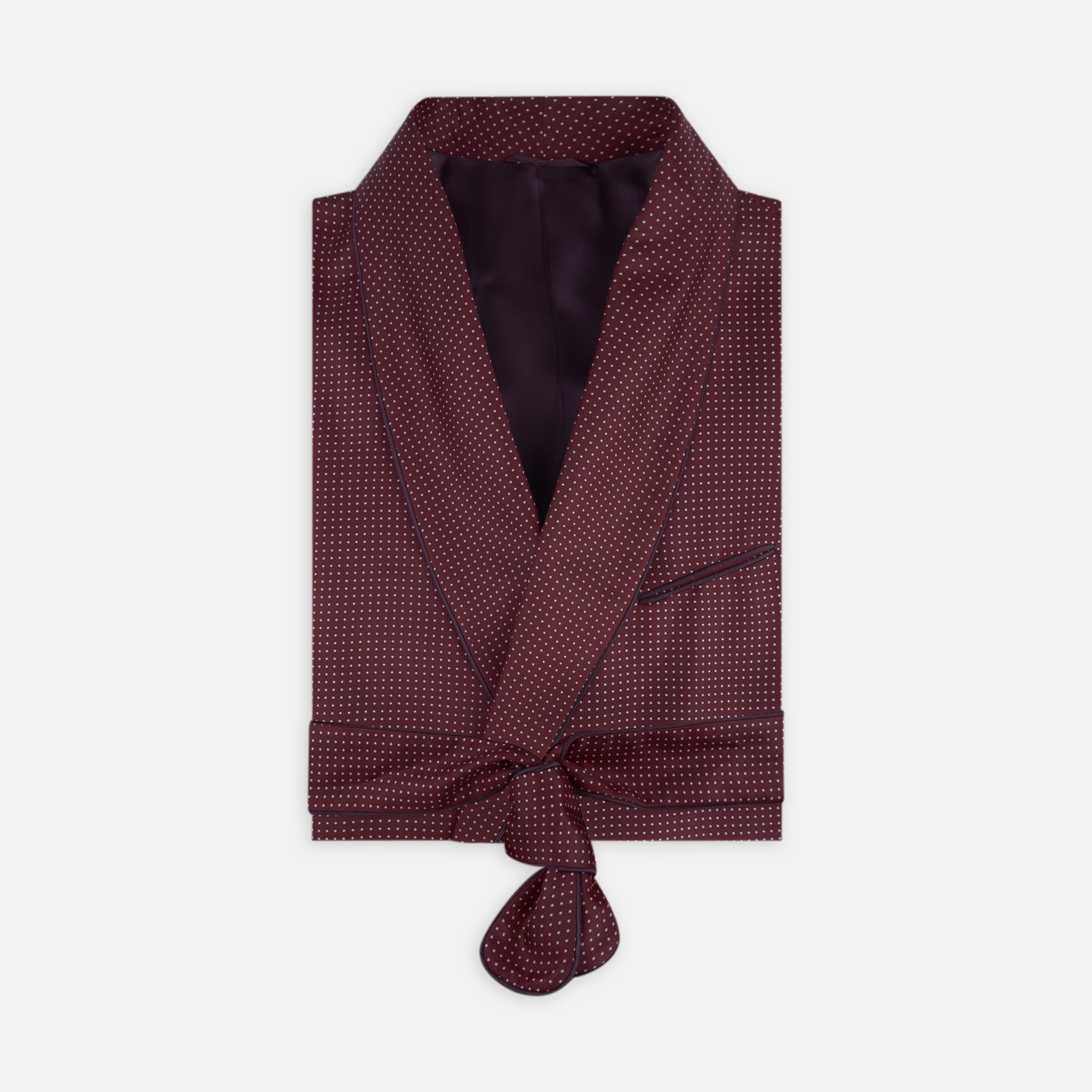 View 1 of product The Turnbull & Asser Burgundy Piped Silk Spot Gown features small white polka dots, a shawl collar, fabric belt, and chest pocket—luxurious nightwear and a stylish men’s statement piece—shown on a white background.