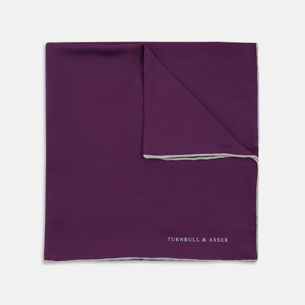 This elegant Plain Purple Silk Pocket Square with White piping by Turnbull & Asser is the perfect suit accessory for the discerning gentleman.