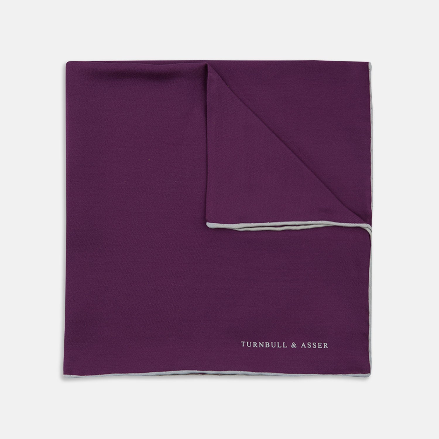 View 1 of product This elegant Plain Purple Silk Pocket Square with White piping by Turnbull & Asser is the perfect suit accessory for the discerning gentleman.