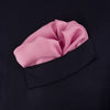 View 4 of product The Rose and Navy Piped Silk Pocket Square by Turnbull & Asser features classic pink silk with navy edging, neatly folded to display both sides. Turnbull & Asser’s logo appears in white on the lower right corner for a refined finish.
