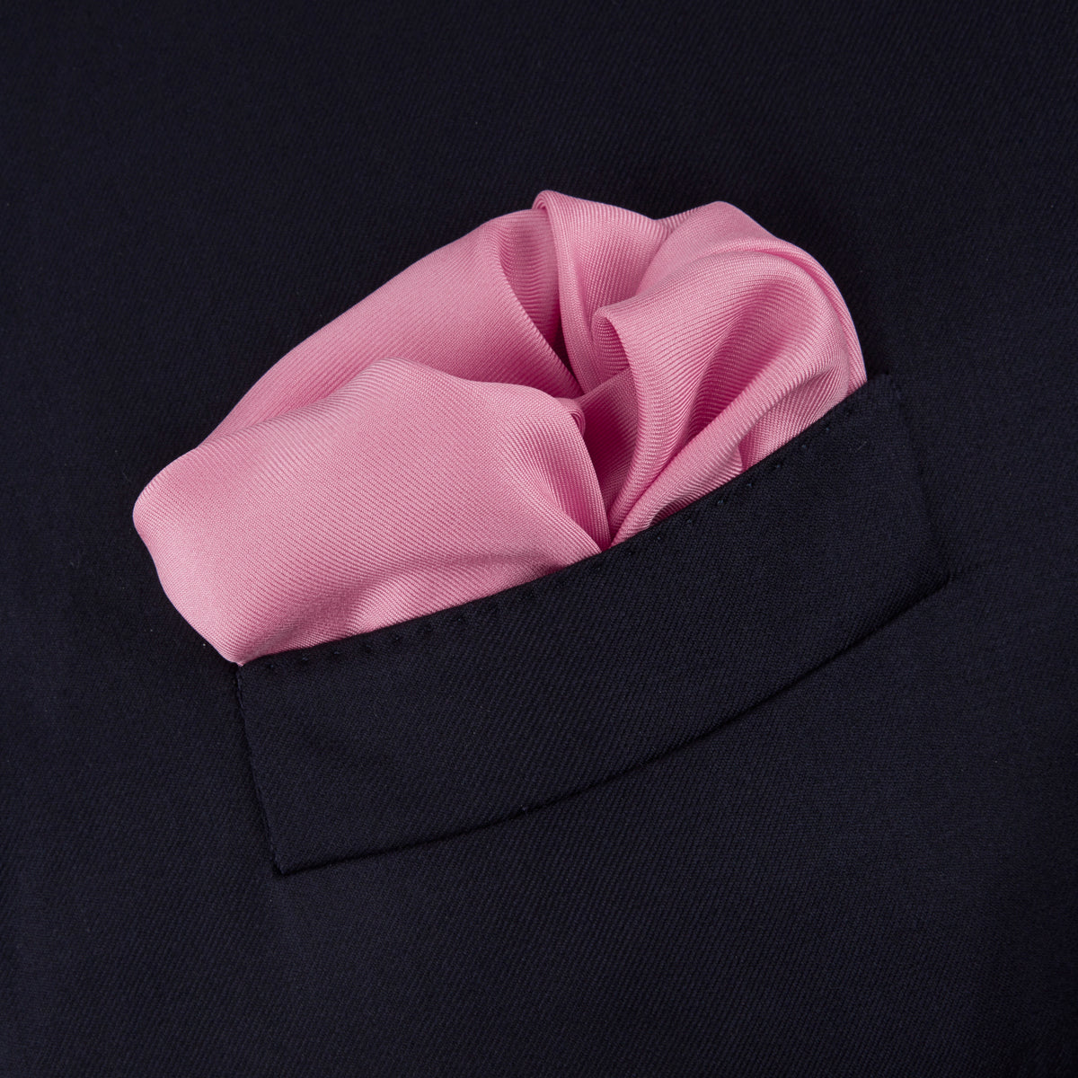 View 4 of product The Rose and Navy Piped Silk Pocket Square by Turnbull & Asser features classic pink silk with navy edging, neatly folded to display both sides. Turnbull & Asser’s logo appears in white on the lower right corner for a refined finish.