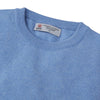 View 2 of product The Turnbull & Asser Sky Blue Fine Cashmere Crew Neck Jumper features long sleeves with ribbed cuffs and hem, shown against a plain white background.