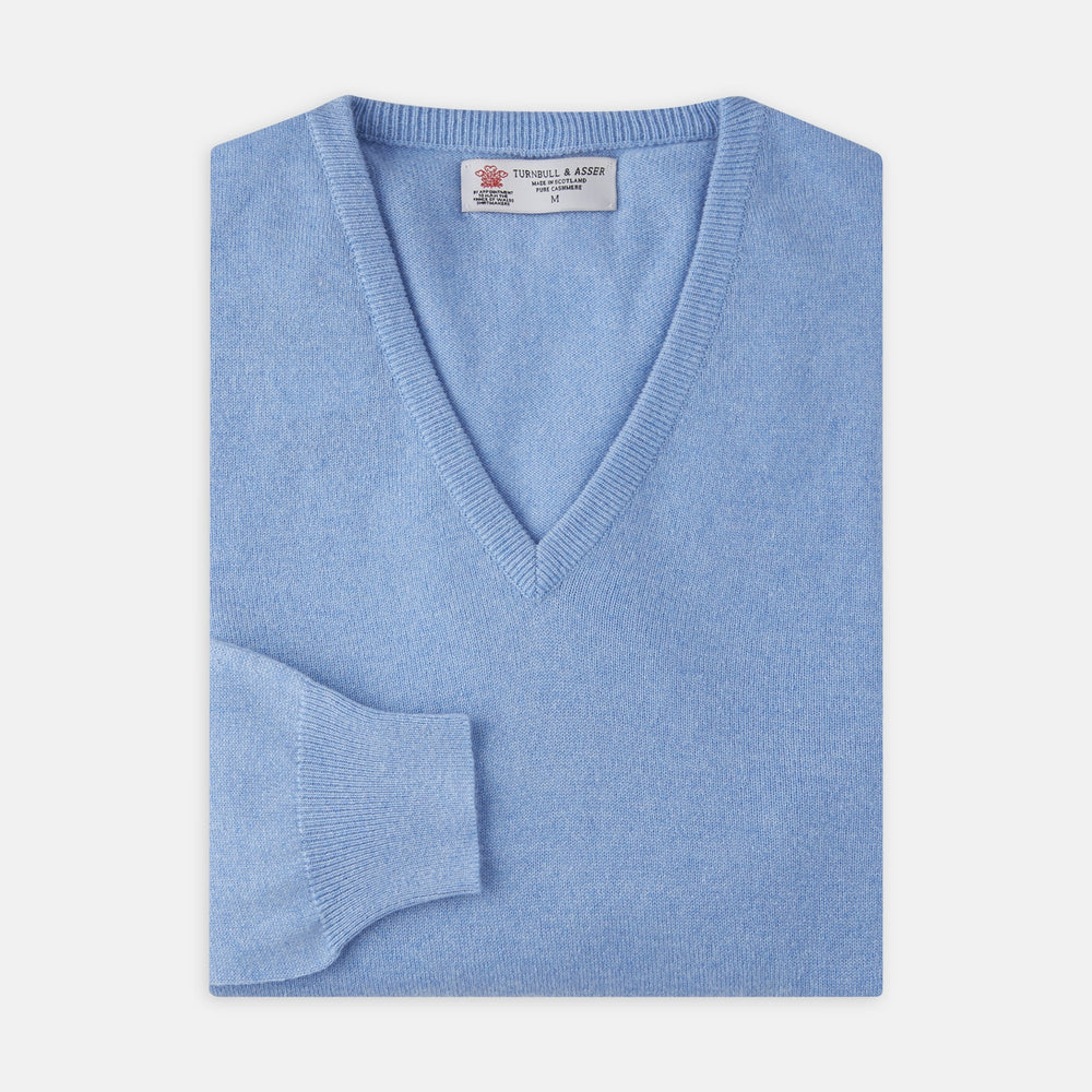 A Sky Blue Fine Cashmere V-Neck Jumper by Turnbull & Asser, neatly folded with visible ribbed collar and cuff, is displayed on a white background. The label appears inside the collar.