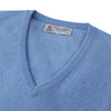 View 2 of product A Sky Blue Fine Cashmere V-Neck Jumper by Turnbull & Asser, neatly folded with visible ribbed collar and cuff, is displayed on a white background. The label appears inside the collar.