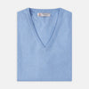 View 4 of product The Sky Blue Fine Cashmere Slipover by Turnbull & Asser is laid flat on a white background, showcasing its lightweight design and ribbed neckline, armholes, and hem for a refined finish.