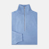 View 1 of product The Turnbull & Asser Sky Blue Half-Zip Cashmere Jumper is neatly folded with the zipper partially closed and one sleeve tucked underneath, displayed on a white background.