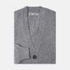 View 4 of product The Grey Fine Cashmere Cardigan by Turnbull & Asser is a long-sleeve, button-up sweater with two front pockets, shown on a white background.