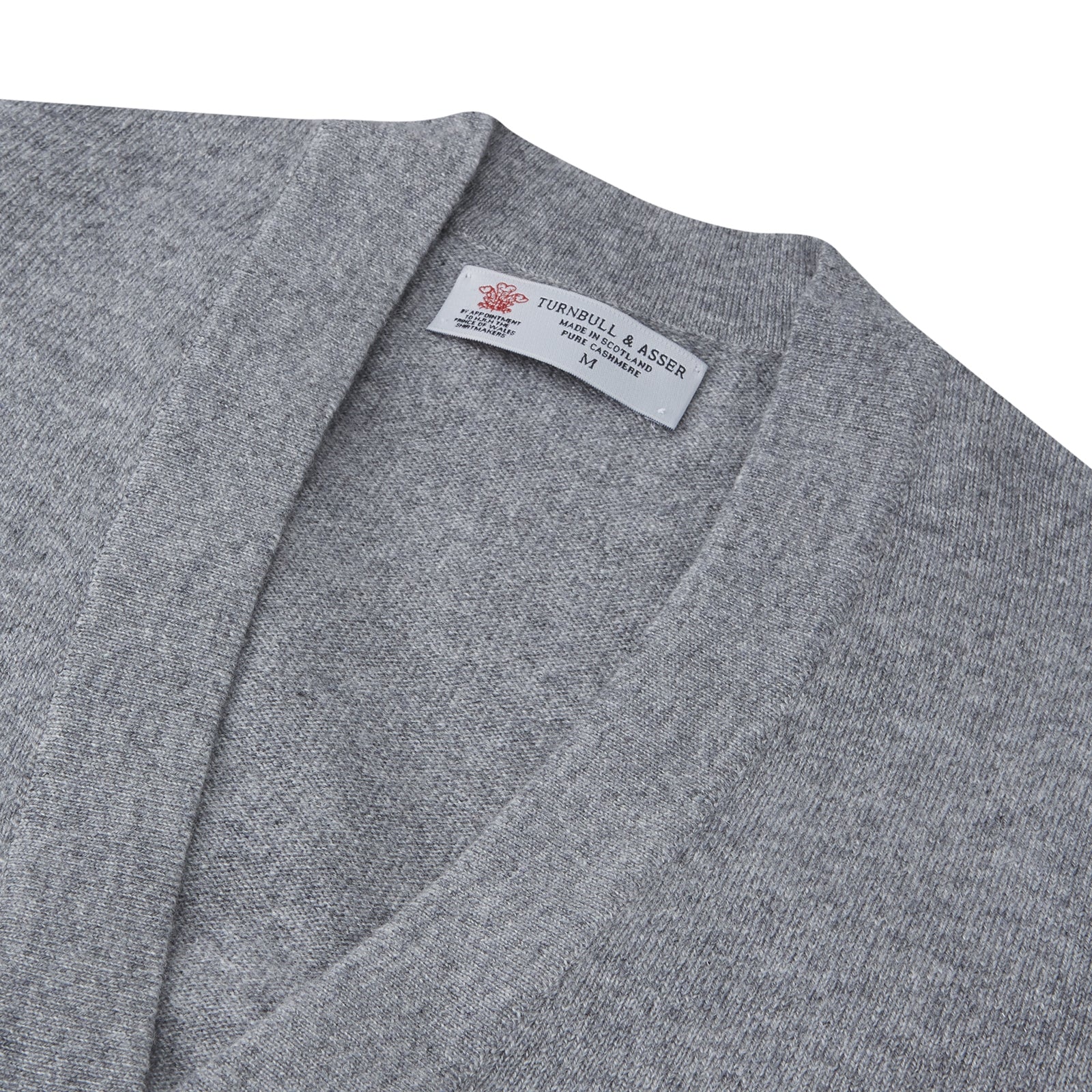 View 3 of product The Grey Fine Cashmere Cardigan by Turnbull & Asser is a long-sleeve, button-up sweater with two front pockets, shown on a white background.