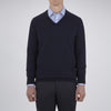View 2 of product The Turnbull & Asser Indigo V-Neck Merino Wool Jumper, shown neatly folded with ribbed cuffs and a visible inner label, is a timeless essential in versatile navy, perfect for any gentleman’s wardrobe.