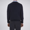 View 3 of product The Turnbull & Asser Indigo V-Neck Merino Wool Jumper, shown neatly folded with ribbed cuffs and a visible inner label, is a timeless essential in versatile navy, perfect for any gentleman’s wardrobe.