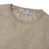View 2 of product The Camel Fine Merino Crewneck Jumper by Turnbull & Asser is a light brown Scottish knitwear piece with a ribbed collar and cuffs, neatly displayed on a plain white background.