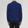 View 3 of product The Blue Crew Neck Cable Knit Cashmere Jumper by Turnbull & Asser features a chunky cable knit, ribbed crew neck and cuffs, and a visible label inside the collar.