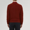 View 3 of product The Harissa Crew Neck Cable Knit Cashmere Jumper by Turnbull & Asser features a chunky, folded cable knit in deep harissa, with ribbed crew neckline and cuffs, and a signature label on the inside collar.