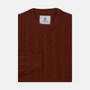 View 1 of product The Harissa Crew Neck Cable Knit Cashmere Jumper by Turnbull & Asser features a chunky, folded cable knit in deep harissa, with ribbed crew neckline and cuffs, and a signature label on the inside collar.