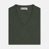 View 1 of product The Turnbull & Asser Green V-Neck Cashmere Slipover is neatly folded with the brand and size tag visible, displayed flat on a plain white background.